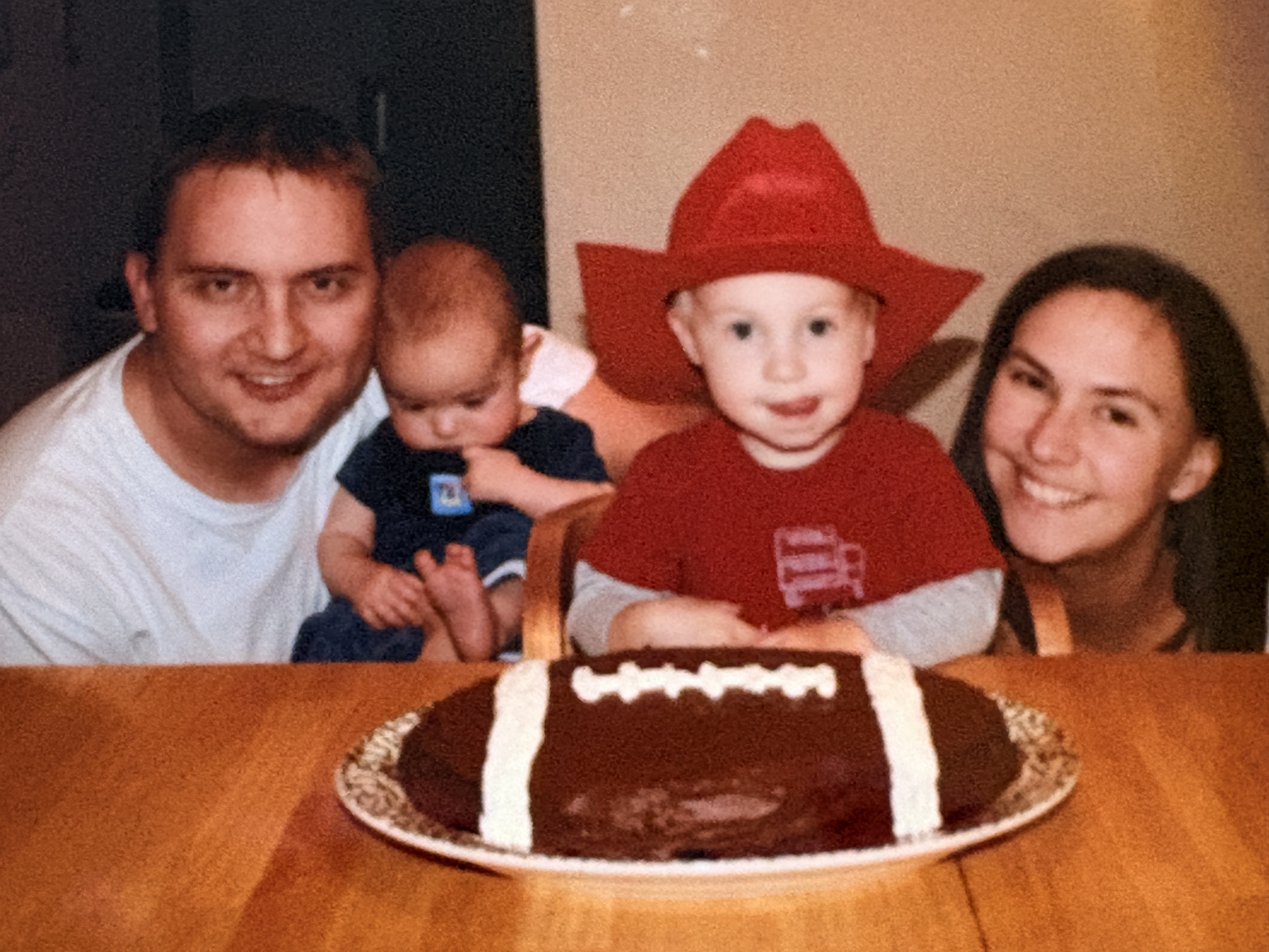 The family gathered around a football-shaped birthday cake